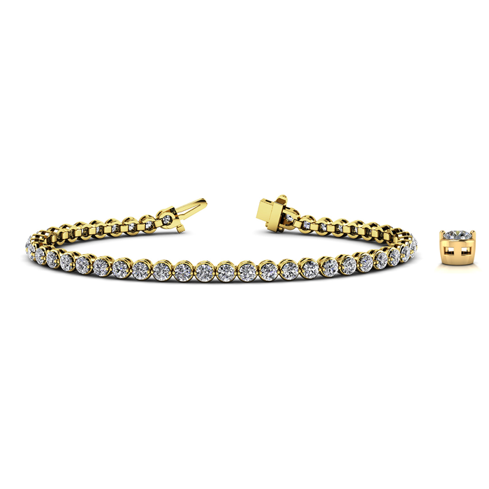 A luxurious gold tennis bracelet adorned with round white gemstones lies elegantly open on a pristine surface.